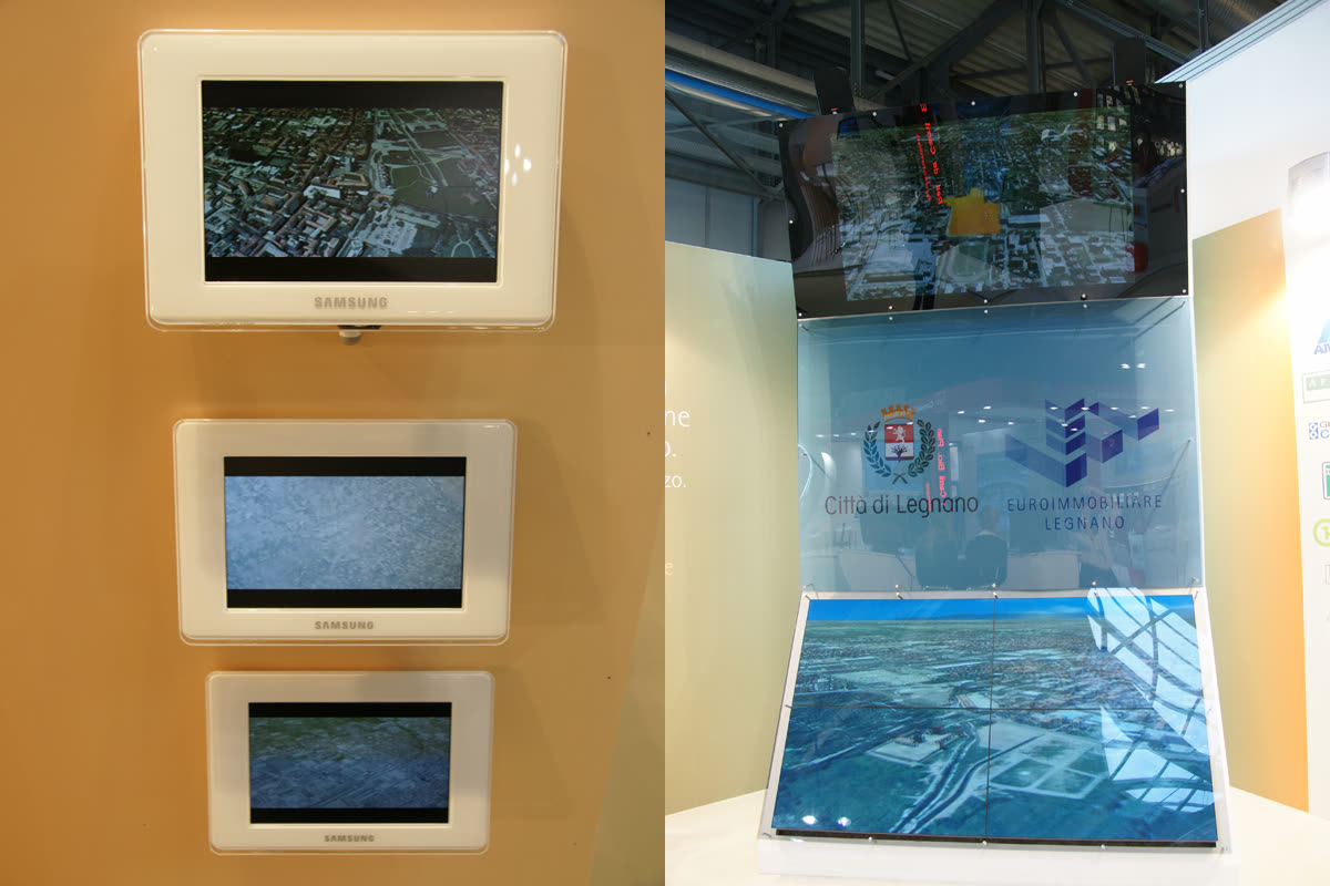 Cornici digitali Samsung e monolite-schermo dello stand con render 3D della città