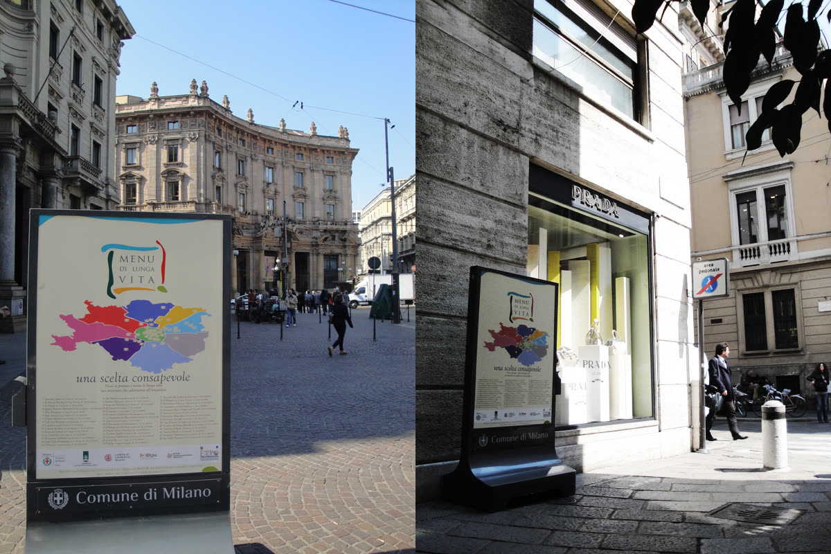 Totem Menu di Lunga Vita in piazza a Milano e davanti a una vetrina Prada